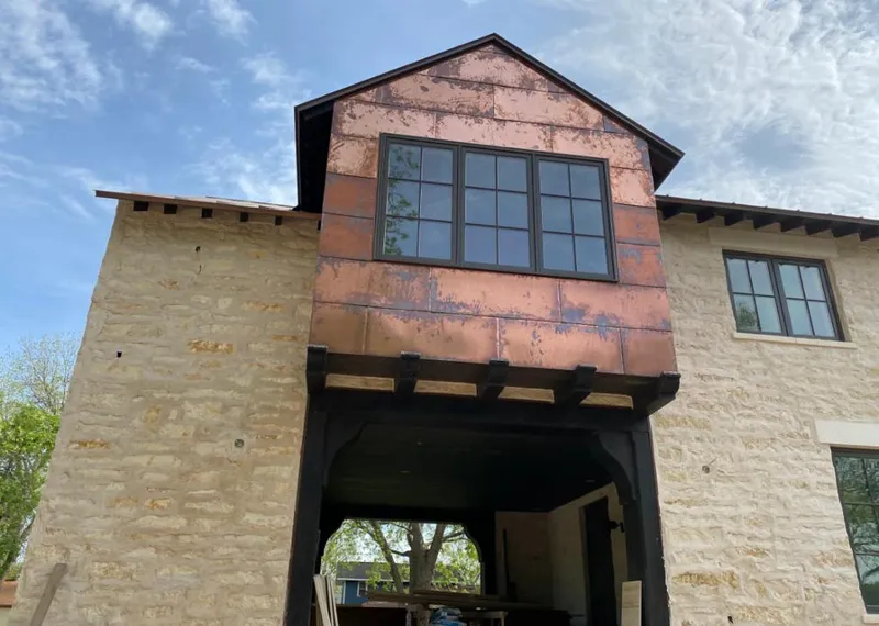 Copper metal panel facade on a stone building for Metal Roof Coating in Berkley